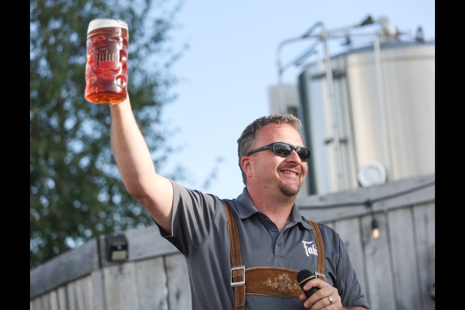 Brewmaster Jochen Fahr raises a mass of his maibock at Brauerei Fahr's Oktoberfest celebration in Turner Valley on Sept. 17. 