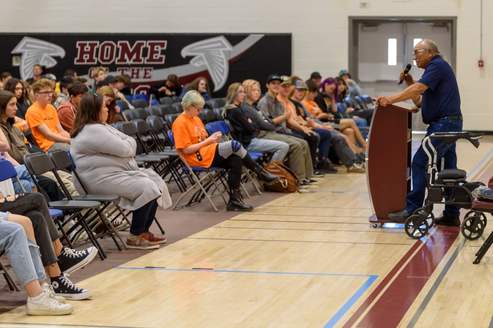 Francis Wolfleg, a member of Siksika Nation, speaks at an assembly held to commemorate Orange Shirt Day at Foothills Composite High School in Okotoks on Oct. 3. Wolfleg spoke  spoke about his experience in residential school, the Indian Act, and how all people in Treaty 7 lands are treaty people.
