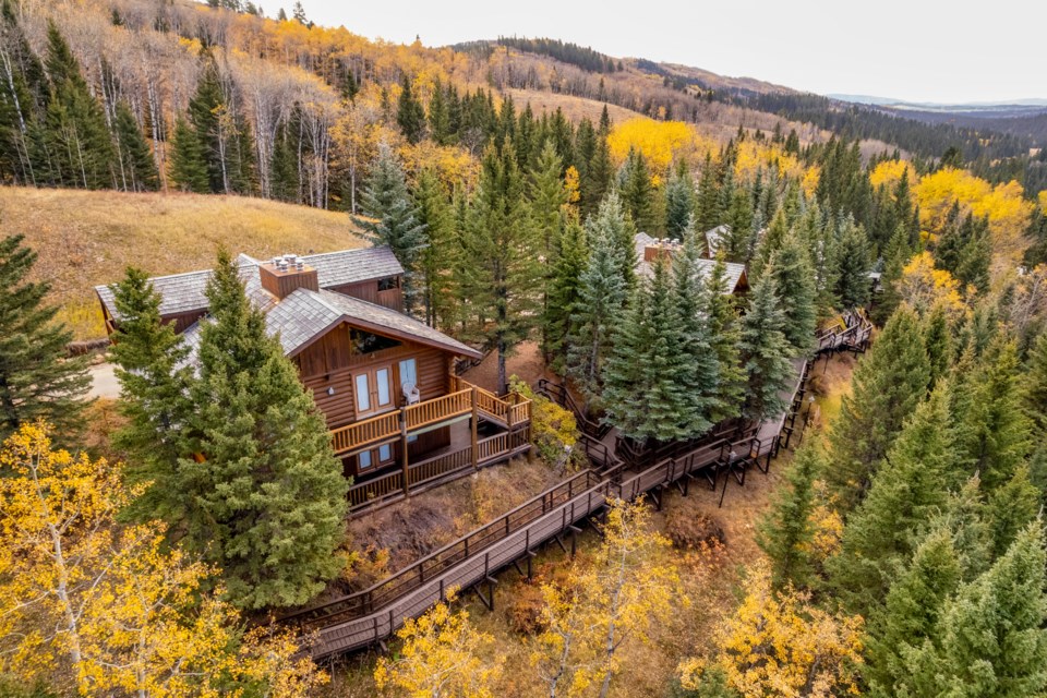 Guest cabins are connected to the main lodge by an elevated walkway at The Ranch at Fisher Creek. The 480-acre property is on the market for $25.5 million.