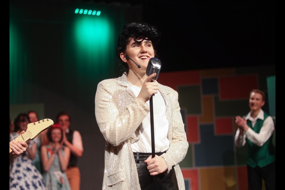 Conrad Birdie (played by Tayah Funk) sings on the Ed Sullivan Show in the musical theatre production of Bye Bye Birdie on Dec. 9. The rockabilly-era Alberta High School of Fine Arts production tells the story of an Elvis-inspired heartthrob going off to war, his producer's plan to keep his record label afloat, and the drama that ensues.