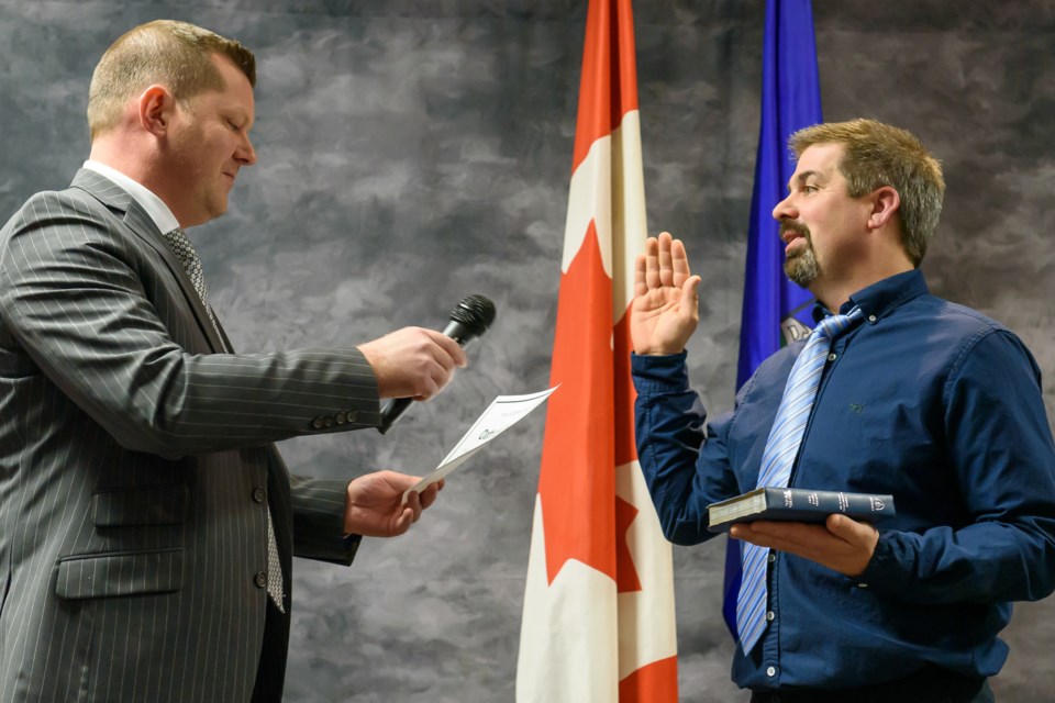 Highwood MLA RJ Sigurdson, left, swears in Mayor Barry Crane to council at the Legion in Diamond Valley on Jan. 9.