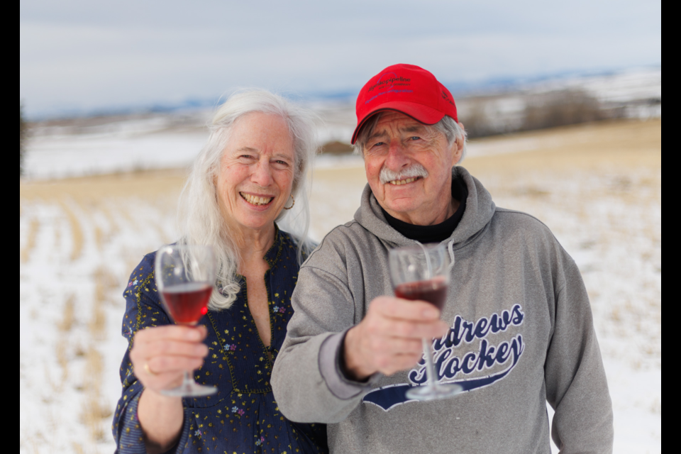 Cherie and Art Andrews, proprietors of the Chinook Honey Company and Chinook Arch Meadery lift a glass of their buckwheat mead on Feb. 19, 2023. The two are hanging up their beekeeper hoods after nearly two decades in the bee business.
