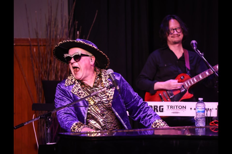 Rob Skeet performs as Cyril Tenjohn with the Husky Tower Band in a musical tribute to Elton John at the Rotary Performing Arts Centre in Okotoks on March 3, 2023.