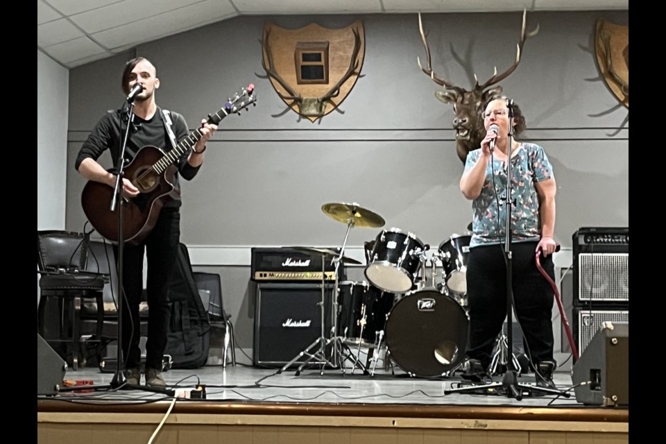 Colton Conway is joined on stage by his mom Colette at the all-ages open mic night at the Okotoks Elks Hall on March 9.