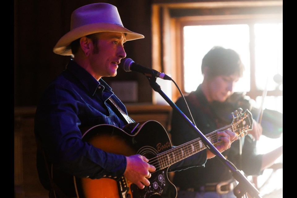 Boots Graham performs with Catherine Robertson on fiddle in the Sandy Strong benefit concert at the Twin Cities Saloon on March 12. The sold-out concert was held to raise funds for Sandy Cooper-Black, an injured 16-year-old cowboy from Consul, Sask.