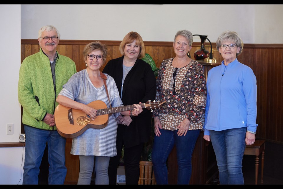 Mel Ternan, Sheena Read, Shirle Ternan, Colleen Fernley and Jude Van Seggelen pose in the DeWinton United Church on March 17 where they will perform in the Joyful Noise casual choiring concert featuring the songs of Fleetwood Mac.
