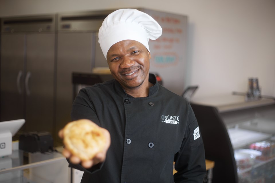 Ubuntu Pies proprietor Xolani Ncube holds out one of his savory pies in his High River bakery on March 18. Ncube has baked up a trivia game fundraiser for March 30 at the Highwood Centre where the participants must eat progressively spicier pies with each question answered.