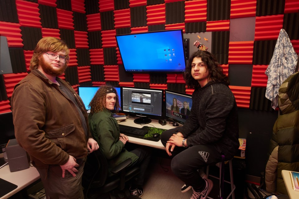 From left, Wynn Brown, Cooper Felker, and Kiyan Karimaghari work in the Foothills Composite High School/Alberta High School of Fine Arts video editing suite on March 15.