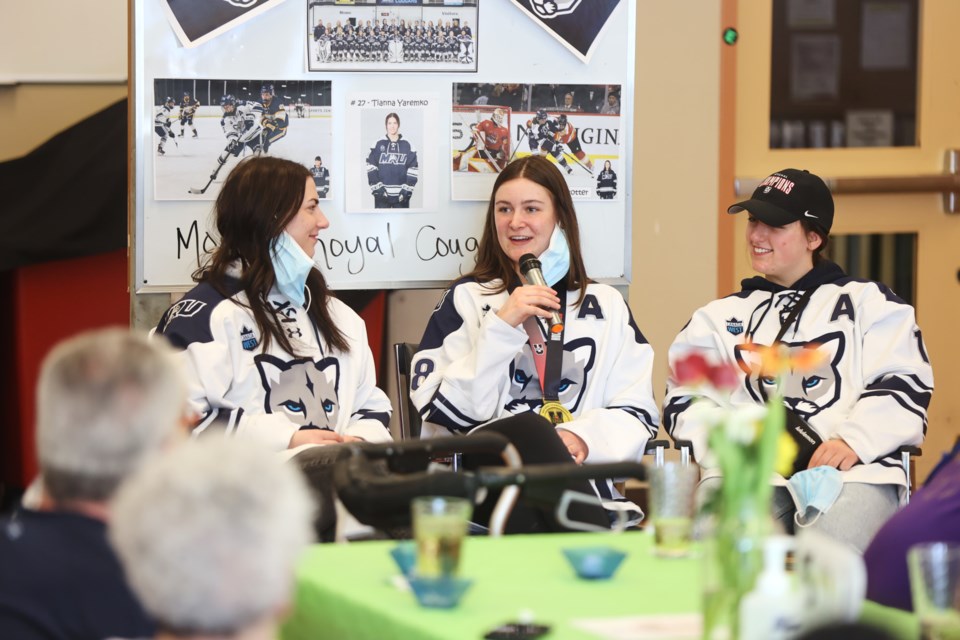 MRU Cougars (L-R) Tianna Yaremko, Okotokian Breanne Trotter and Lyndsey Janes speak with residents of Tudor Manor during a visit on March 24.