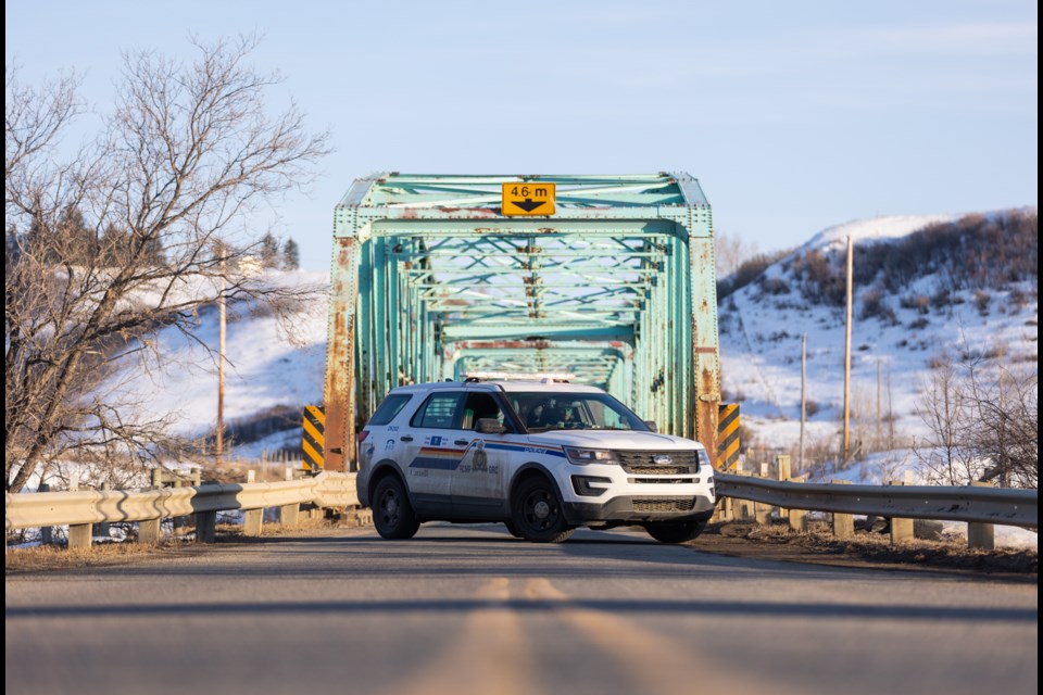 A police cruiser blocks the Highway 552 bridge over the Highwood River on March 30, 2023 following the discovery of a body in the area. On Jan. 18, 2024, police arrested four people in connection with the murder of 37-year-old Tara Miller of Calgary.