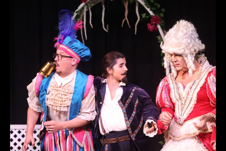 The Countess Olivia (Brad Fowler, right) speaks to her uncle Sir Toby Belch (Safia Elder) of his over-consumption as the Fool (David Elder) attempts a surreptitious sip in Shakespeare's Twelfth Night by the Dewdney Players on May 10, 2023.