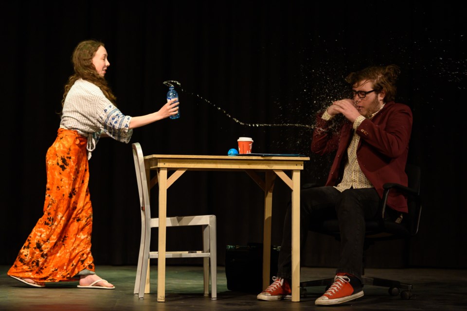 Layla Cannon, left, as a vegan, splashes water on Warner Hodgins, as an interviewer, during rehearsals for the play students wrote called 'A How-Not-To Guide to a University Interview' at Oilfields High School on May 16. The class will perform the play in the school's theatre on May 26 and 27.