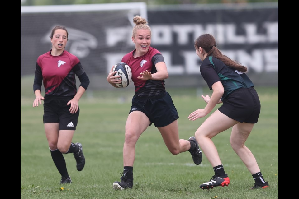 Foothills Falcons back Savanah Sommerfeldt runs the ball during a victory over the Holy Trinity Academy Knights. Foothills edged Bow Valley 21-15 in the South Central Zone Tier I final on May 31 at the Calgary Rugby Union to advance to the ASAA Provincial Rugby Championships. 