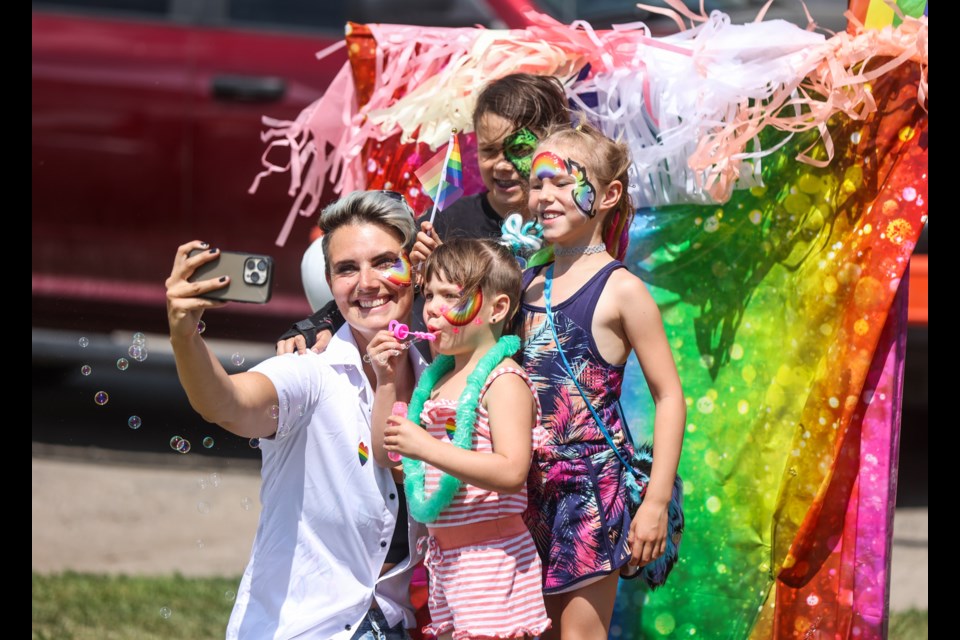 Stephanie Rose takes a selfie with her kids Goose, John, and Natalie during the Youth Celebration Expo at the Okotoks Landmark Site on June 4. The event was organized by the True Colours Rainbow Alliance and featured family-friendly activities such as face painting, balloons, cotton candy, market vendors, as well as potato sack and three-legged races.