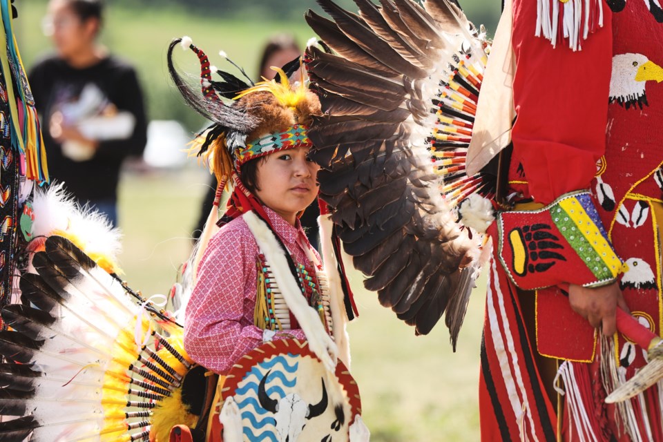 Slade Cutter of Siksika lines up for the grand entry during a powwow at Chief Jacob Bearspaw School on the Eden Valley Reserve on June 8.