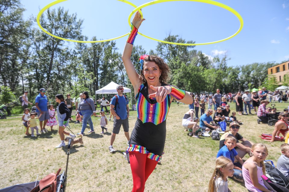 Hula Hoop Circus artist Amanda Panda twirls hoops running through the crowd during Okotoks Children's Fest at Ethel Tucker Centennial Park on June 17.