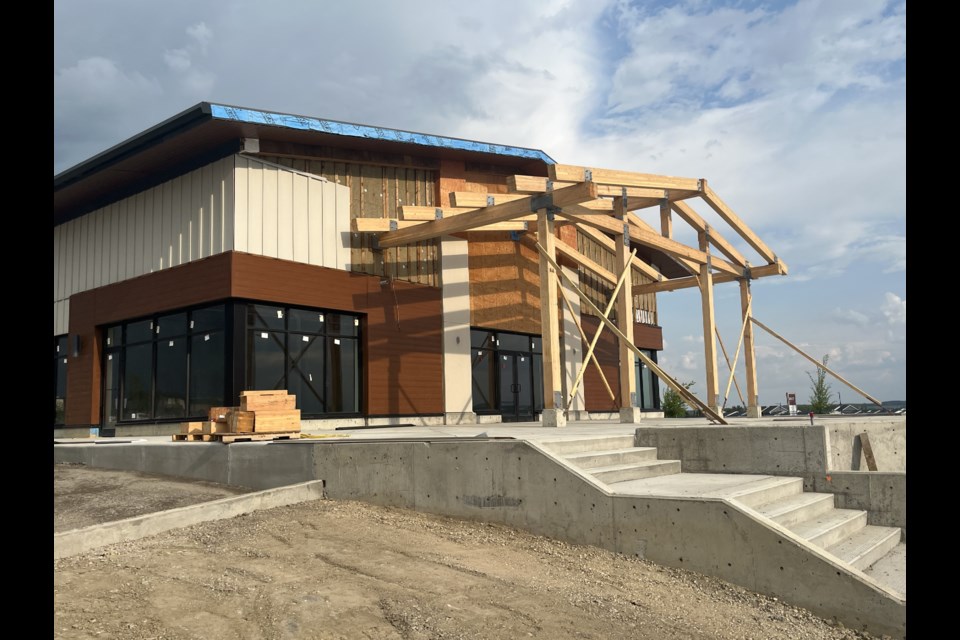 A restaurant space in the southwest corner of the site includes a patio with views of the Rockies.