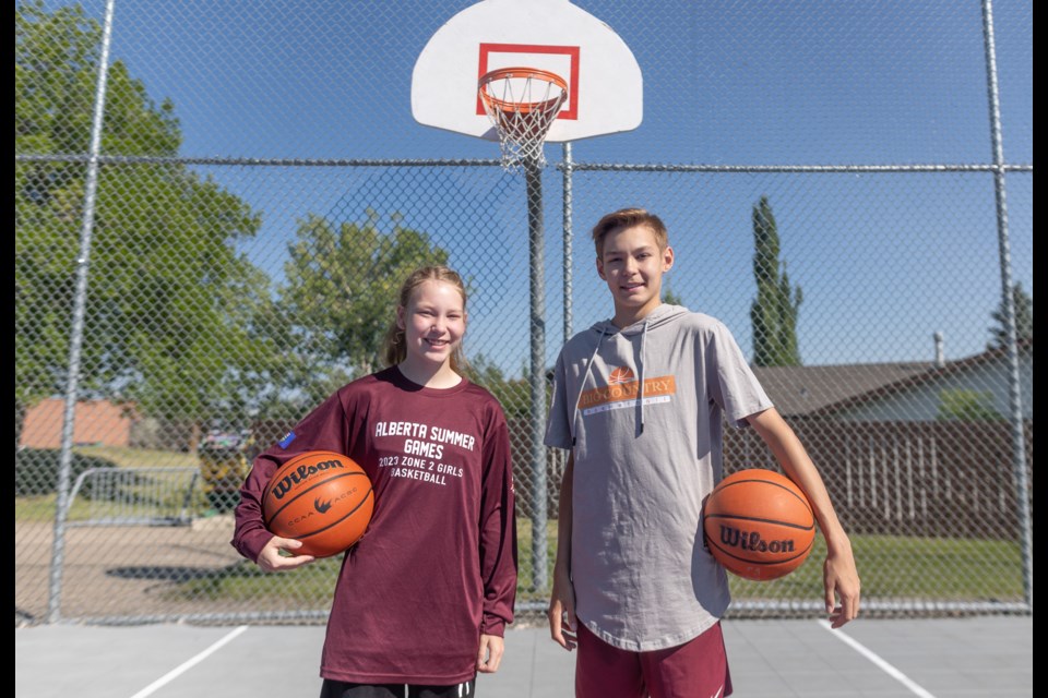 (Left and right) Twins Rylee and Bracen Lybbert pose at the Woodhaven basketball courts on June 29. Both will be playing in the Alberta Summer Games.