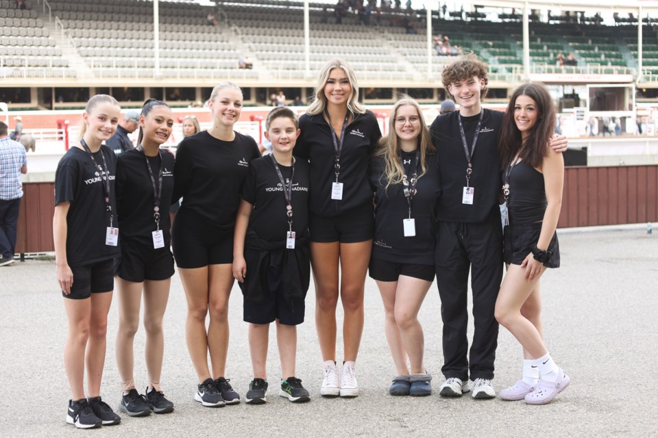 Okotoks-area members of the Young Canadians (from left) Hadley Janssen, Cleavon Abree Laquibla, Natallii Bencharski, Nash Bencharski, Taylor Atkinson, Felicia Jackson, Jack Leathwaite, and Maya Pawlick pose at the GMC Stadium before their Grandstand Show at the Calgary Stampede on July 7.