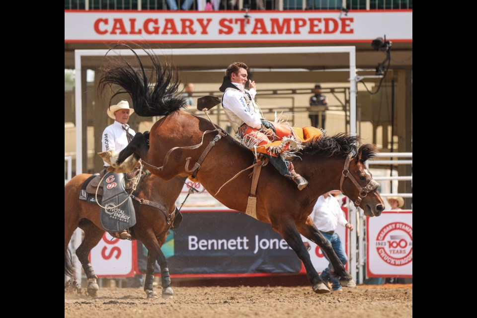 Clayton Biglow rides Zulu Warrior bareback for a score of 83.5, coming out on top for day one of the Calgary Stampede Rodeo on July 7.