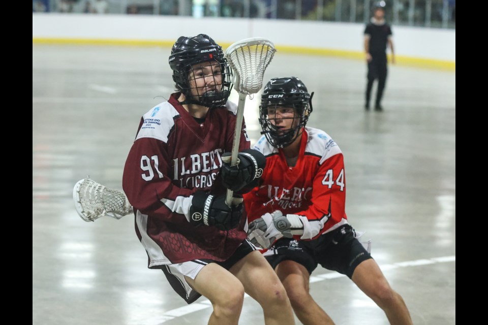 Okotoks' Jamie Jackson of the Zone 2 lacrosse team keeps possession versus Zone 3 in the 2023 Alberta Summer Games gold medal game at Murray Arena on July 23. Zone 2 won by a 5-4 score in overtime.