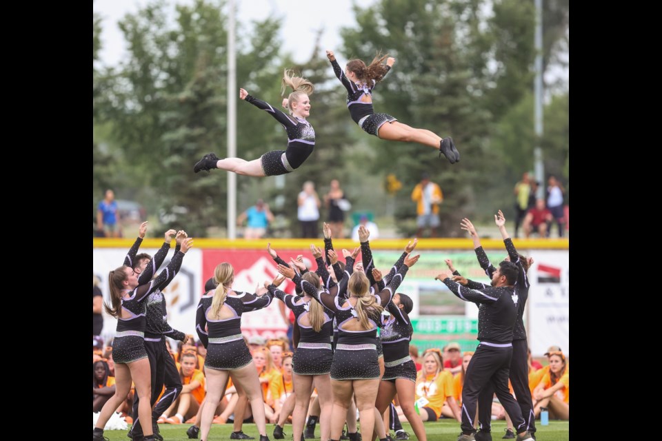 Cheerleaders from Perfect Storm Athletics perform in the opening ceremony for the 2023 Alberta Summer Games at Seaman Stadium in Okotoks on July 20.