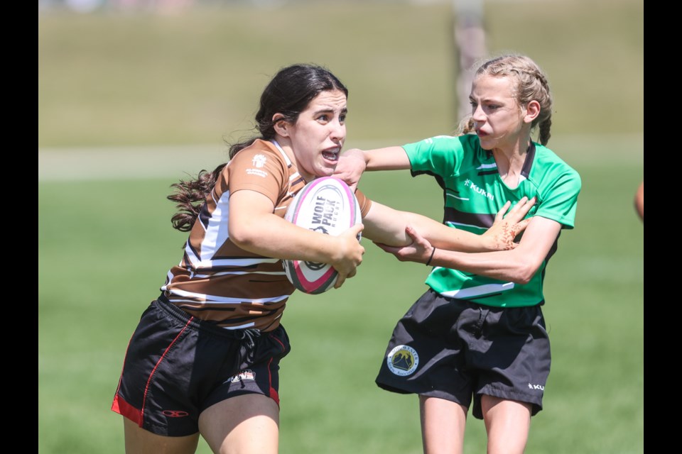 Okotoks' Nadia Pacione, of the Zone 2 girls, runs forward in girls rugby sevens action at the Alberta Summer Games on July 21 at Wylie Park.