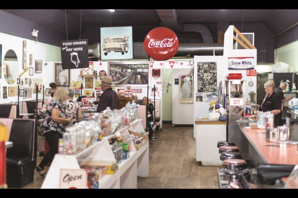 The walls of Marv's Classic Soda Shop are lined with vintage signs, antiques, and other ephemera, as well as classic selection of sodas and candy.