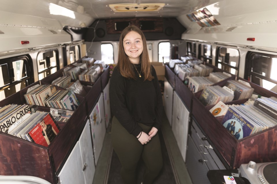 Jaica Tipper poses in her mobile record shop, dubbed the Beatnik Bus, on June 22. After starting the business in an Okotoks commercial space last year at the age of 17, the vinyl-loving teen took the enterprise on the road.