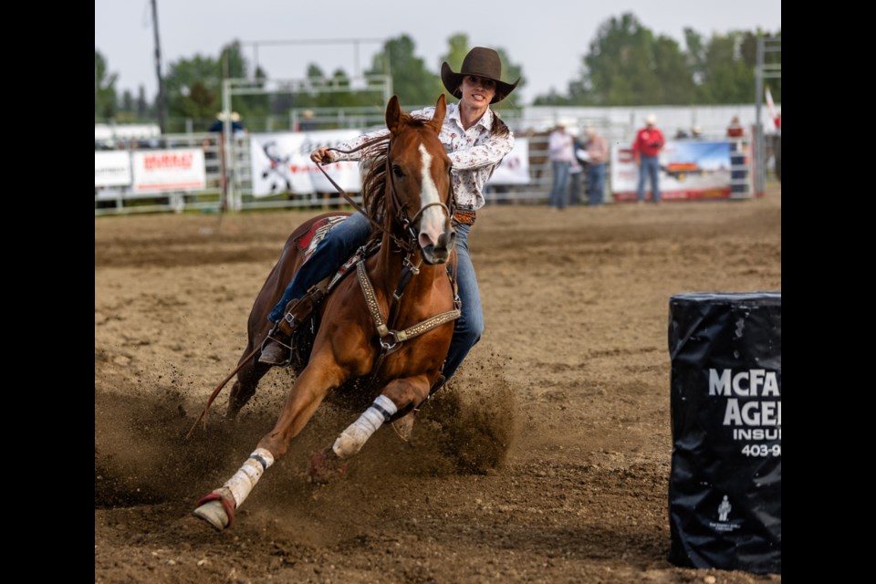 Barrel racer Lane Wills speeds for the last turn in the Okotoks Pro Rodeo at the Millarville Racetrack on Aug. 25.