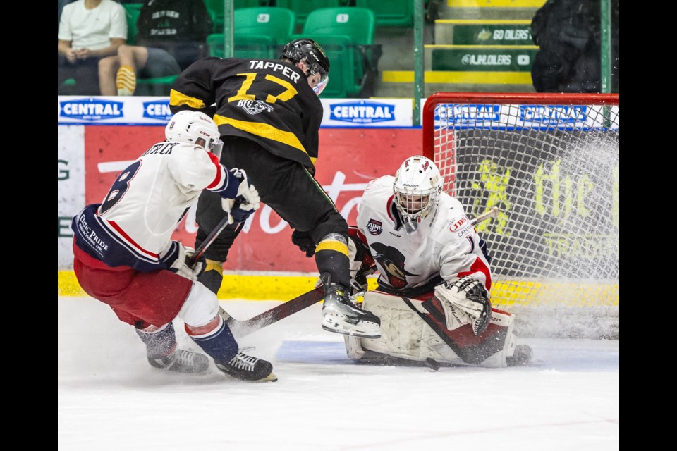 Brooks Bandits goaltender Johnny Hicks blocks a play by Okotoks Oilers forward Jagger Tapper at Okotoks Centennial Arenas on Oct. 14.