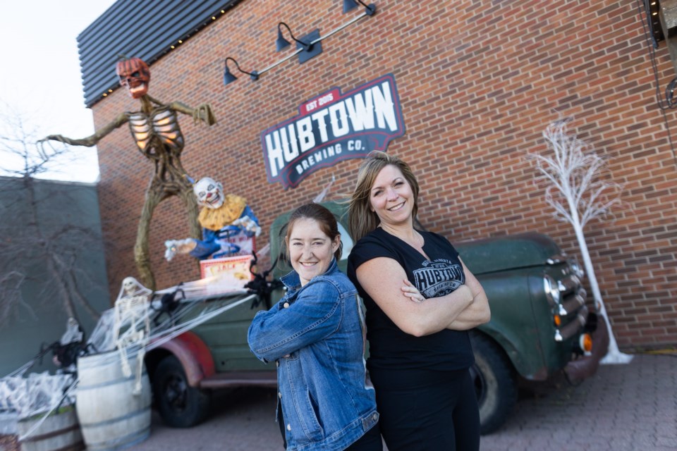 Okotoks Film Society director Katie Fournell and Hub Town Brewing Co. owner Lisa Watts in front of the brewery on Oct. 19. The brewery will be hosting a haunted house in its upstairs taproom put on by the Film Society.