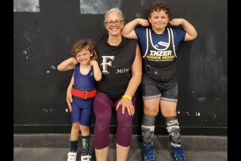 Trina Hampton, middle, and her sons Theo and Logan have all taken to the competition stage in powerlifting.