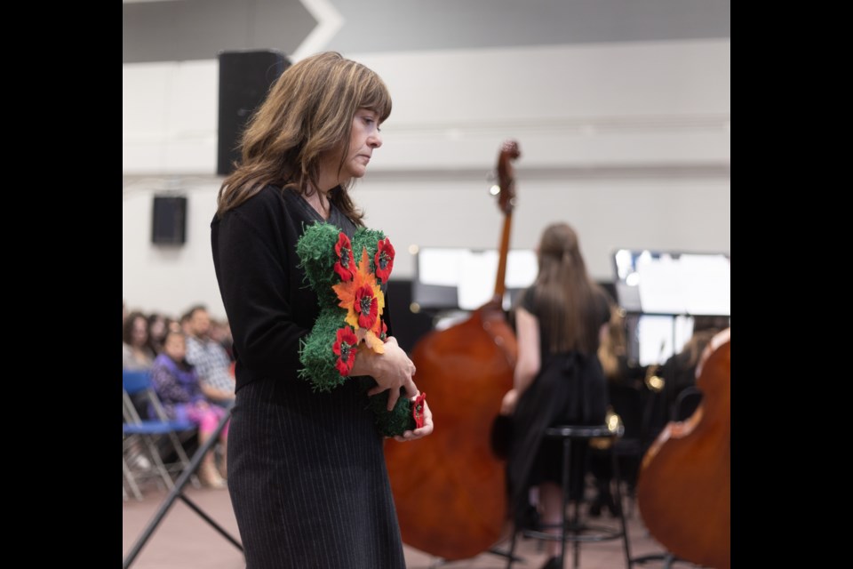 Foothills Composite High School principal Kerry Welsh lays a wreath during the Remembrance Day ceremony at the school on Nov. 10.