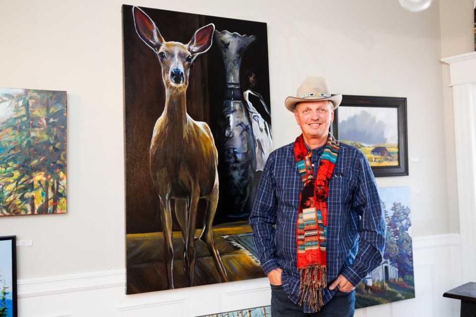 Paul Rasporich poses with his painting 'Meet Jane Doe' at Lineham House Galleries on Nov. 18.