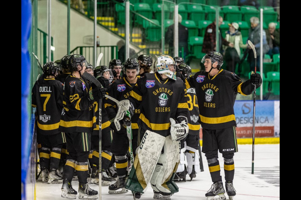 The Okotoks Oilers celebrate their 5-4 overtime win against the Blackfalds Bulldogs at Okotoks Centennial Arenas on Nov. 18.