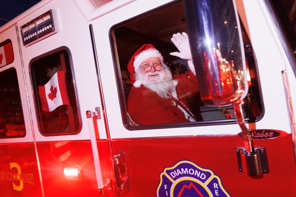 Santa Claus hitches a ride into town in Diamond Valley Fire and Rescue's fire engine for Light Up Diamond Valley on Dec. 2.