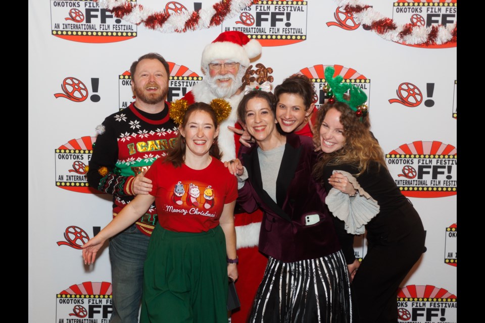 Santa Claus makes a stop on the Okotoks Holiday Film Festival red carpet to pose with Okotoks Film Society members (from left) Patrick Brown, Katie Fournell, Anne-Marie Cotton, Claire Hoyer, and Alyssa Duke on Saturday, Dec. 9.