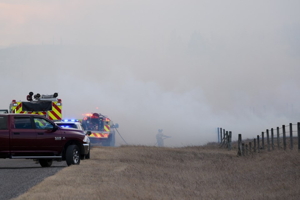 Emergency crews on scene at a large grass fire near Highway 549 and 128 Street West in Foothills County on Dec. 5.