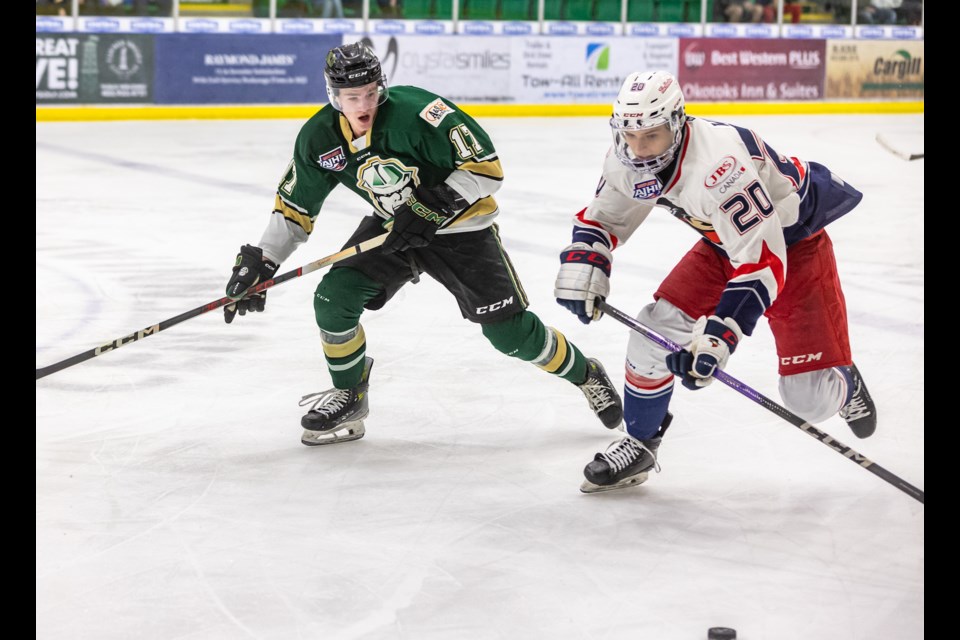 Okotoks Oilers forward Jagger Tapper intercepts Brooks Bandits forward Josh Wiebe in the neutral zone at Okotoks Centennial Arenas on Dec. 8.