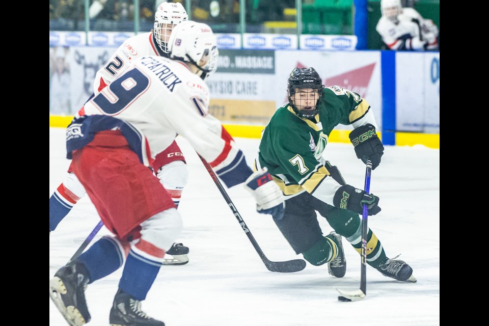 Okotoks Oilers forward Kade Duell moves to avoid the Brooks Bandits at their blue line at Okotoks Centennial Arenas on Dec. 8.
