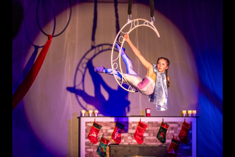 Presley Sutherland of Spectacle Blue Circus Arts performs on a crescent moon hoop in the show 'Twas the Night Before Christmas' on Dec. 16.