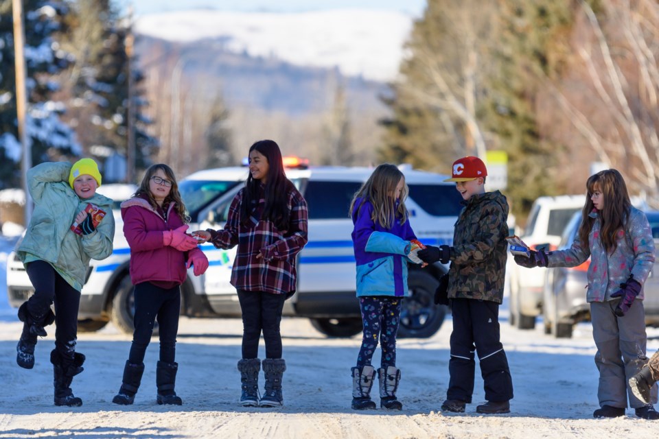 Students from Turner Valley School form a human chain to pass food collected at the school to the Oilfields Food Bank in Diamond Valley on Dec. 12.