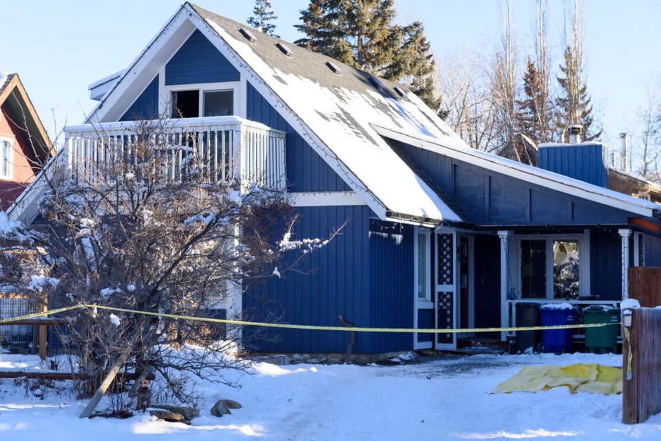 Warning tape surrounds a house in Diamond Valley on Dec. 12, following a fire at the residence on Dec. 11.