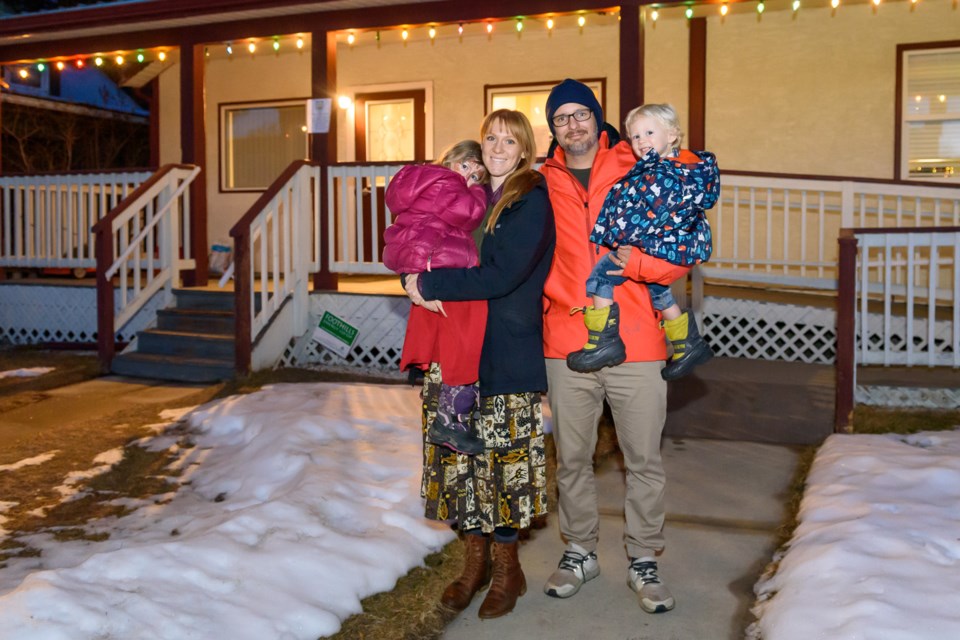 Joe and Heather Bentley with their children Izzy, left, and Rowan, right, attend a potluck fundraiser at the Griffiths Centre in Diamond Valley on Dec. 21. The family expects to be out of their home for at least 10 months following a fire on Dec. 11.