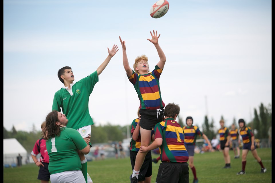 Foothills Lion Quinn Esler, right, goes up for a lineout in action with the VLT team versus the Calgary Irish on June 24 at the Calgary Rugby Union. Esler is headed to the Alberta Summer Games in rugby along with his twin sister Megan, who will play for the Zone 2 girls rugby squad.