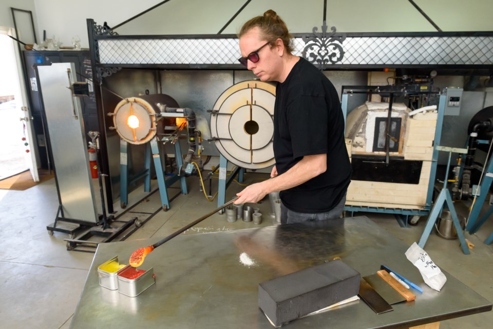 David Blankenstyn creates a glass memorial piece at his studio north of Okotoks on Jan. 5. After losing access to his Facebook ad account in September,  Blankenstyn estimates his business has fallen 95 per cent.