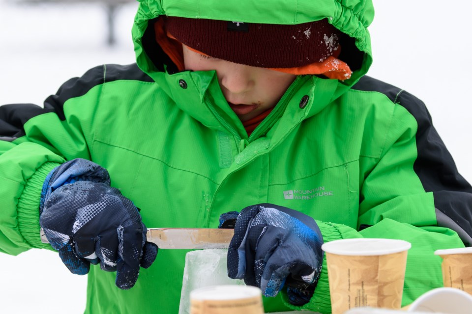 A student works on an ice sculpture during awinter carnival at Dr. Morris Gibson School in Okotoks on  Feb. 6.