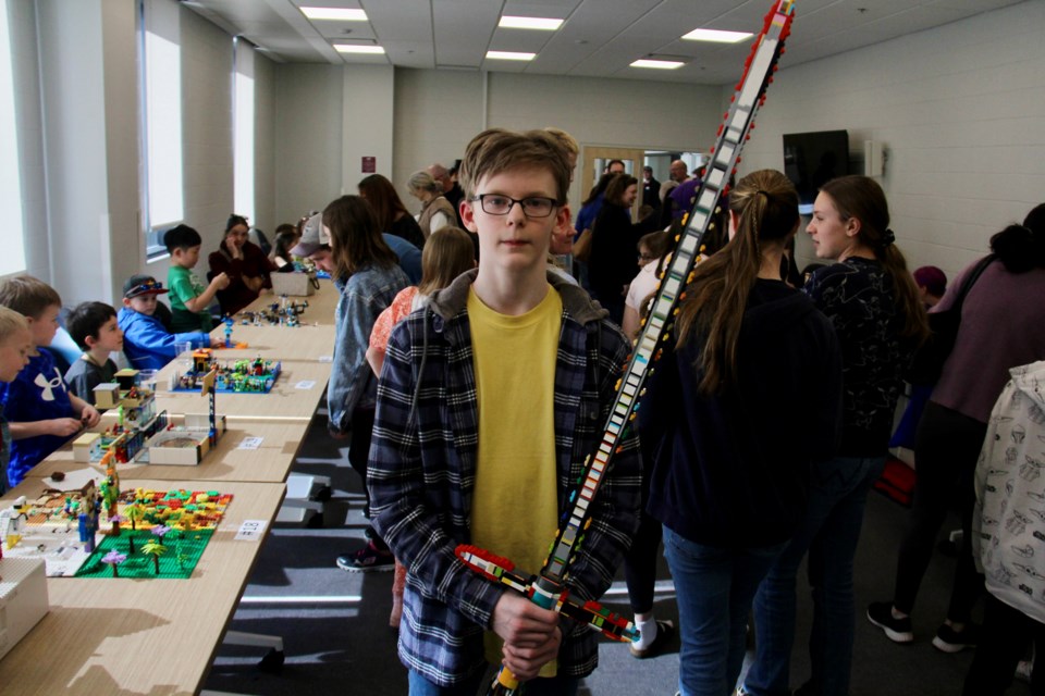 Lochlan Rourke, winner of the Lego contest's 9+ age category, shows off his creation: a life-sized Kylo Ren lightsaber replica. 