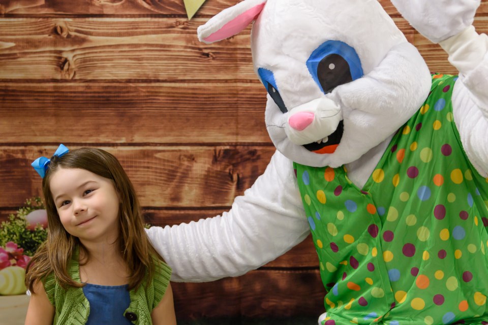 Athena poses for a photo with the Easter Bunny during the Easter Bunny Egg-stravaganza at the Okotoks Recreation Centre on March 22.